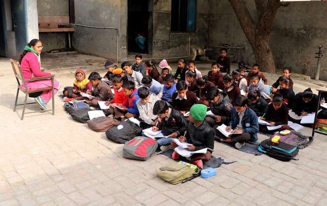 Braving cold, students attend classes in open