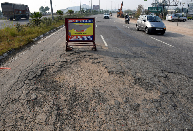 Drive with caution on this potholed road in Zirakpur