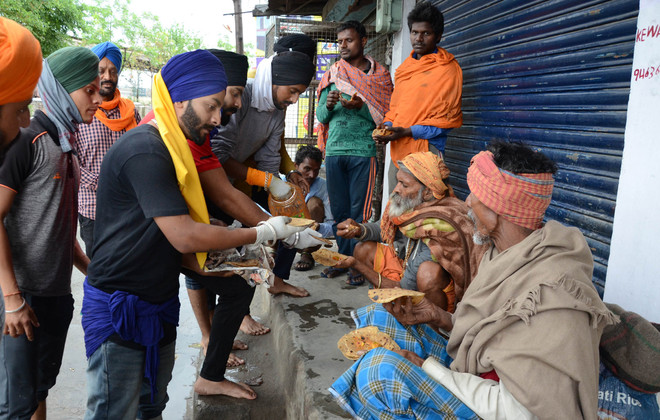 Good Samaritans offer food to poor, stranded migrants