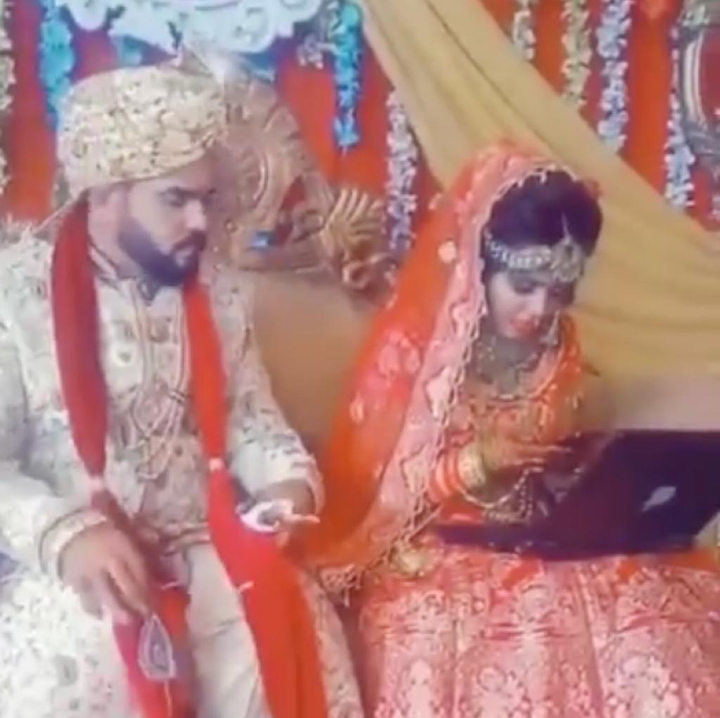 Caught on camera: A bride, glued to her laptop and phone, ignores her groom at the wedding