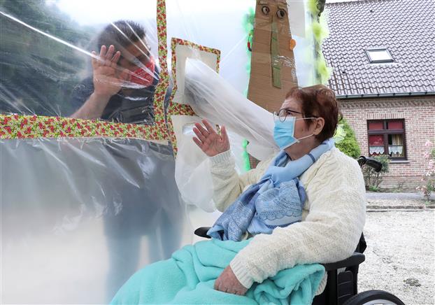 Watch: 'Hugging curtain' installed in Belgian retirement home allows safe embrace during COVID-19 pandemic