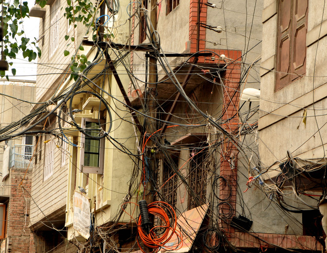Cobwebs of electricity wires an eyesore for residents, trouble for electricians