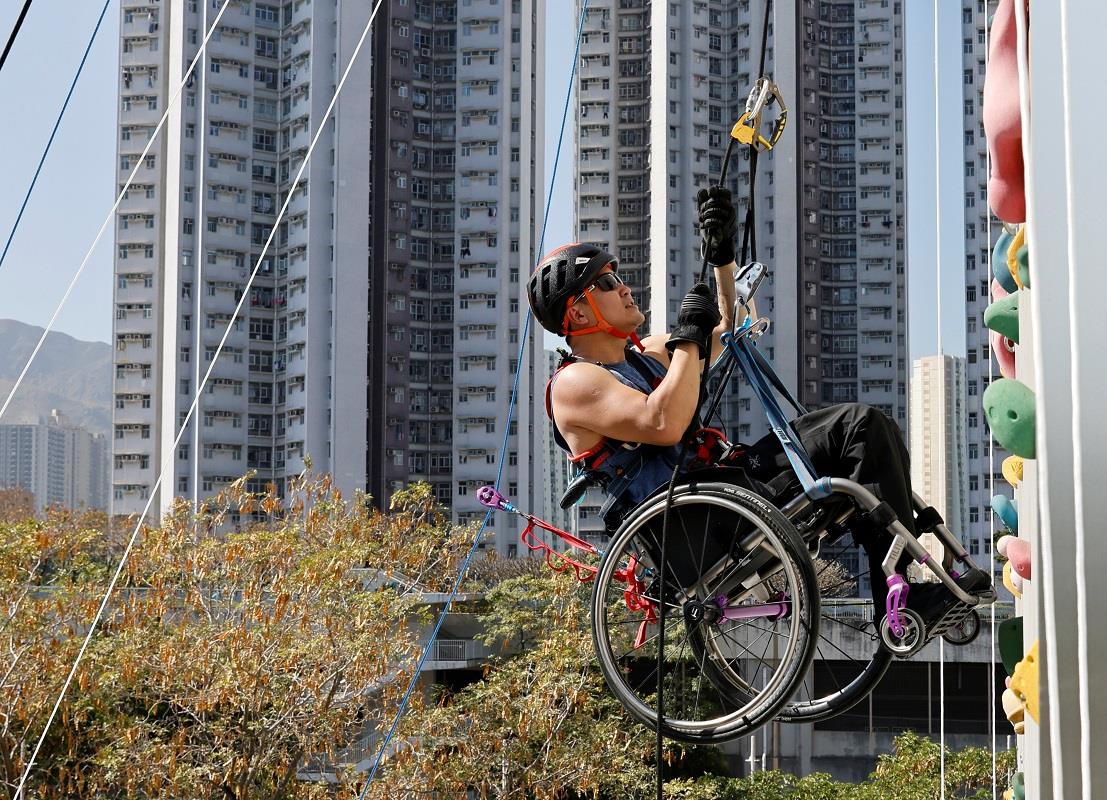 In wheelchair, paraplegic Lai Chi-wai climbs a skyscraper in Hong Kong