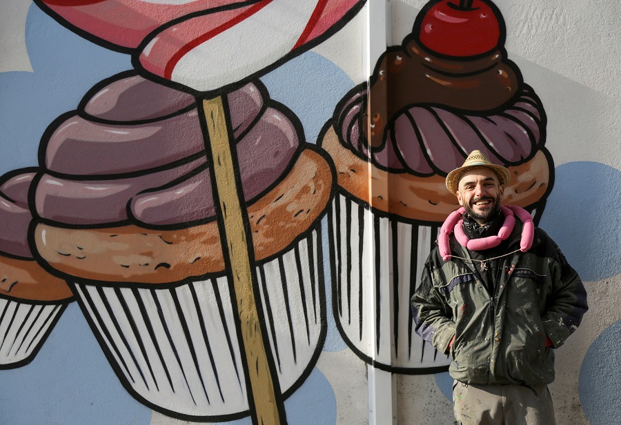 Italian street artist battles racism by turning swastikas into cupcakes