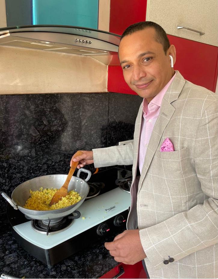 Kanpur Commissioner posts photo of him cooking poha; Twitter says ’who cooks in suit and gas needs to be lit’