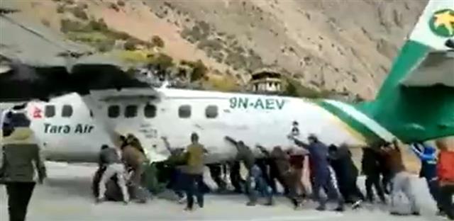 Is it a car? No, it's a plane: Watch people push aircraft on Nepal runway