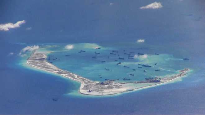 Philippines sends fighter aircraft to fly over hundreds of Chinese vessels in South China Sea