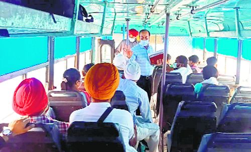 Health officials distribute masks among bus passengers