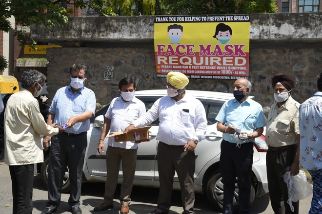 Sanitiser, face masks distributed in Sector 11-D