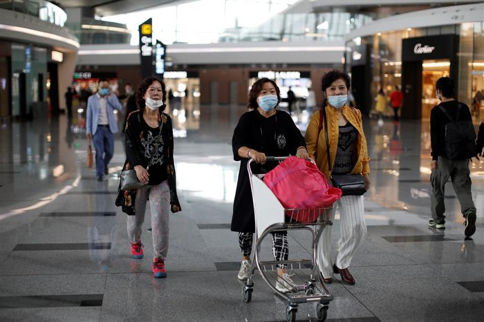 China reports surge of new Covid-19 cases in Guangzhou city, triggering flight cancellations