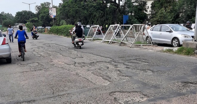 Potholes dot this widely used Panchkula road