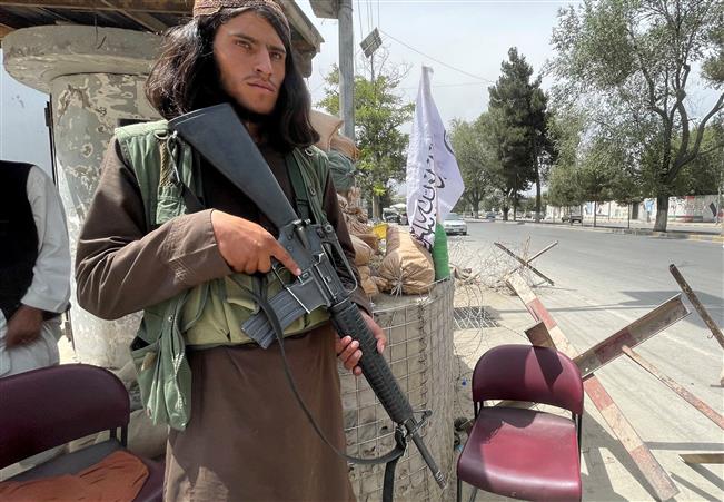 At first news conference, Taliban spokesman promises a secure Afghanistan
