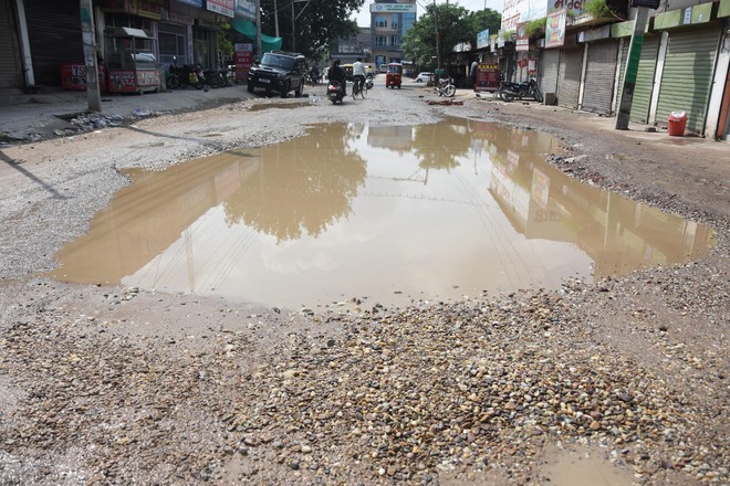 Big potholes on Bachan Singh Marg causing mishaps
