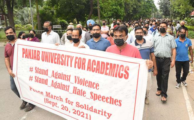 PU employees take  out ‘silent march’