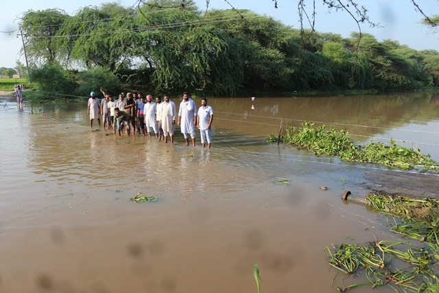 Drain water submerges bridge, enters fields; residents peeved