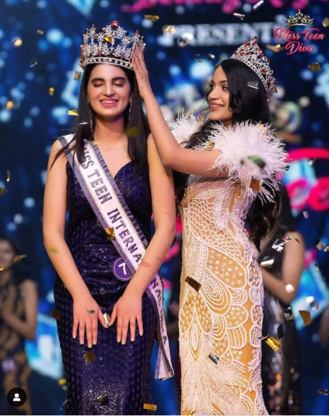 Miss Teen International India winner Mannat holds a banner against child abuse