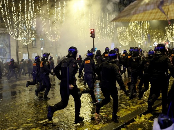 Fans clash with police on Champs-Elysees in Paris after France's World Cup final loss to Argentina