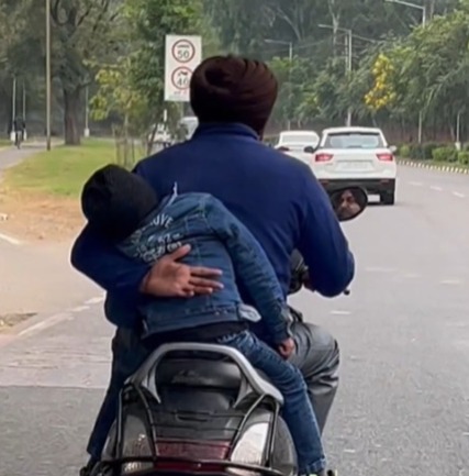 Chandigarh man shields son from falling off moving scooter; Internet has mixed reactions