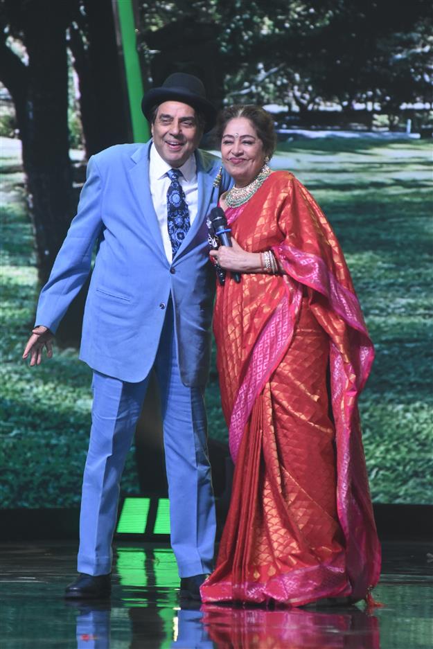 Dharmendra and Kirron Kher enact a scene from Sholay