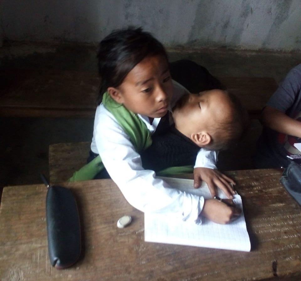 10-yr-old Manipur girl attends classes with younger sister in lap; Minister lauds her 'dedication', says will take care of her education
