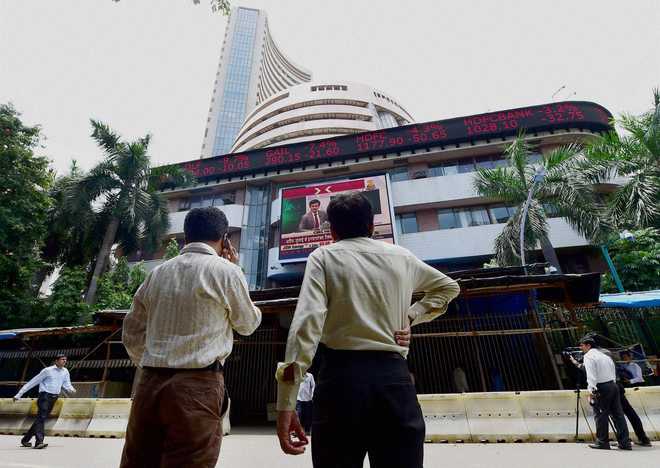Sensex tumbles over 300 points in volatile trade