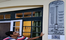 Printed replica of British-era Stephens Inks thermometer installed outside Kasauli hotel