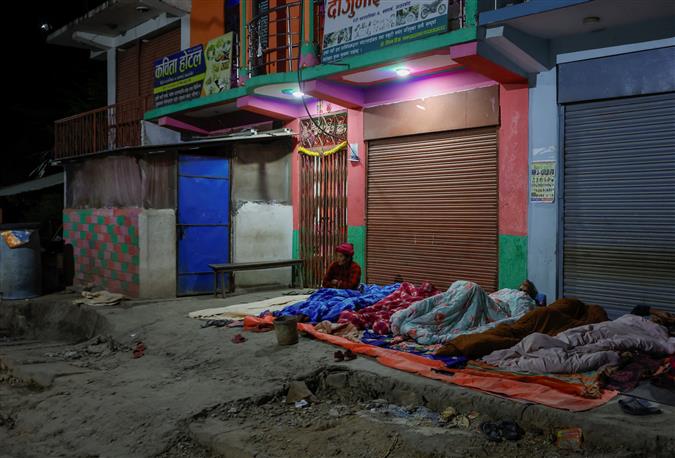 Thousands spend night under open sky in Nepal after earthquake kills 157 people, damages their houses