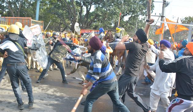 Attacked by protesters with spears, cops run for cover