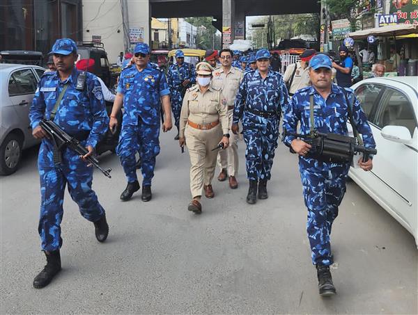 Security forces hold flag march