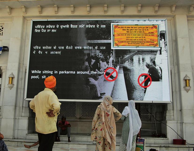 At Golden Temple entrance, big digital screen to guide visitors on dos, don'ts