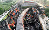 Train accident site: Coaches strewn haphazardly, ambulance wails punctuate noise from electric saws
