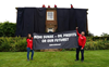 Greenpeace demonstrators drape UK prime minister’s house in black to protest oil expansion