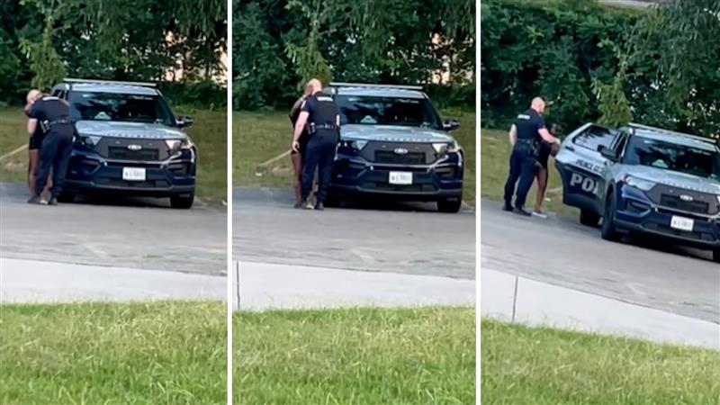 Video: US cop caught kissing scantily clad woman before climbing into police car with her, suspended