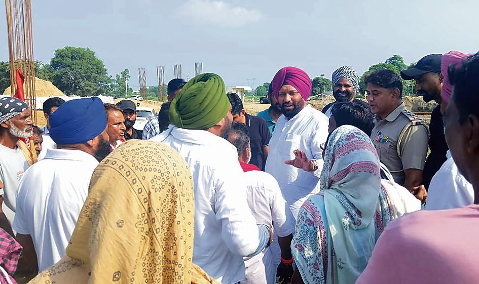 Villagers protest filling of sewage pond for highway
