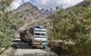Trucks use Gramphu road to transport apple, peas