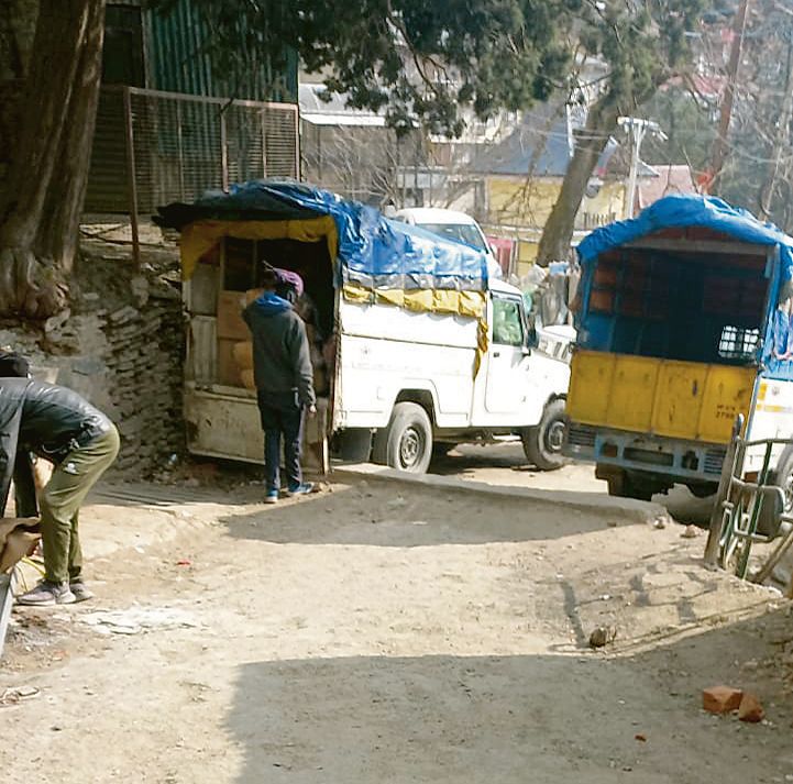 Vehicles parked on narrow road
