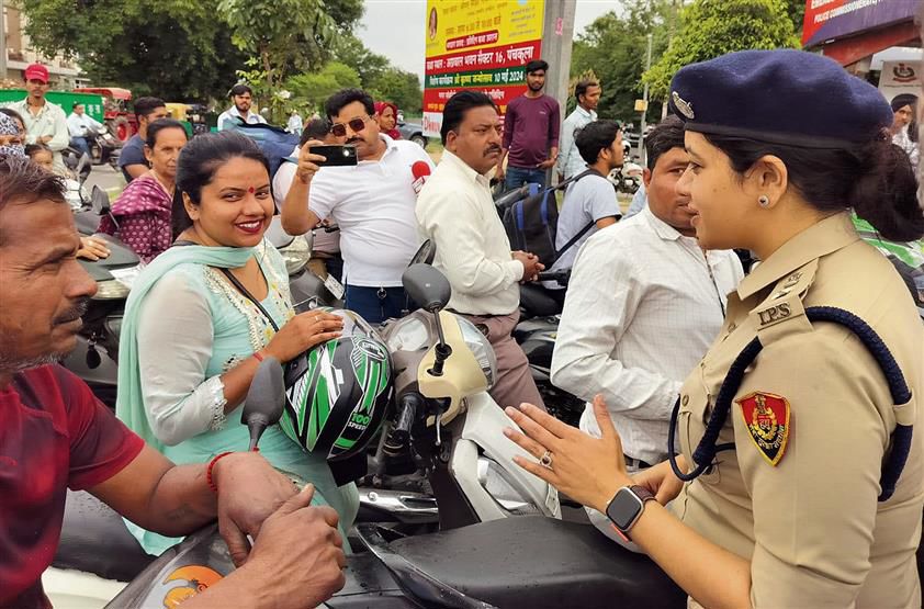 DCP Himadri Kaushik distributes helmets among two-wheeler riders at Panchkula